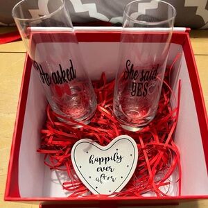 He asked & she said yes toasting glasses with ring dish